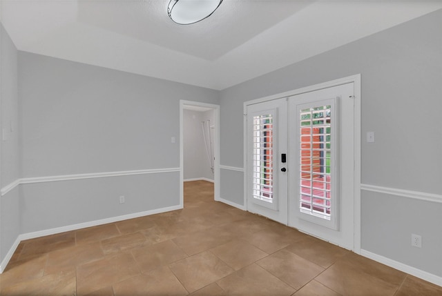 entryway featuring baseboards and french doors