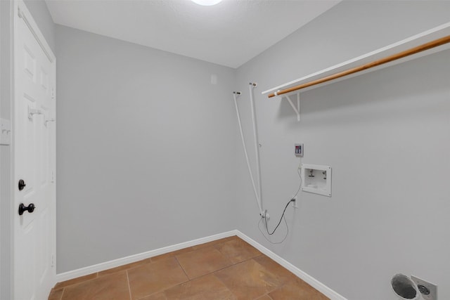 clothes washing area featuring laundry area, washer hookup, baseboards, and tile patterned floors