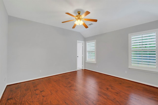 unfurnished room featuring lofted ceiling, baseboards, ceiling fan, and wood finished floors