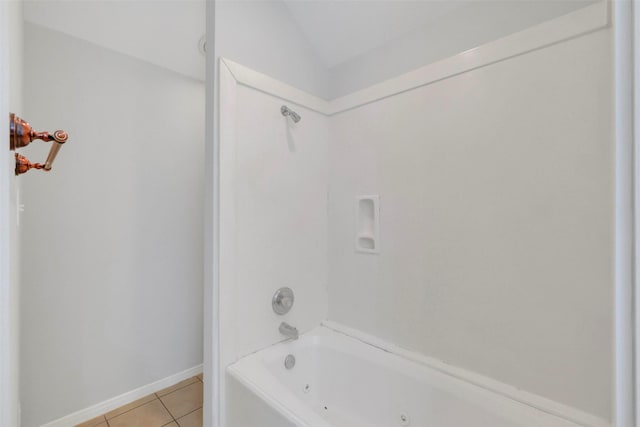 bathroom featuring a combined bath / shower with jetted tub, tile patterned flooring, and baseboards