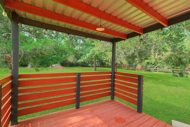 wooden deck featuring a yard and fence