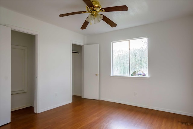 4411 Osage Dr, Baytown, TX 77521 - unfurnished bedroom featuring a ceiling fan, wood finished floors, and baseboards