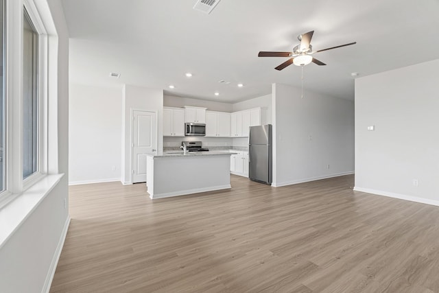 unfurnished living room with ceiling fan, light wood-style flooring, baseboards, and recessed lighting