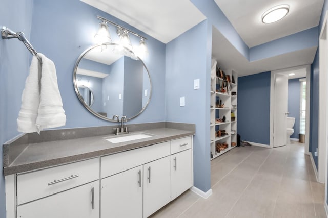 7655 S Braeswood Blvd Unit 10, Houston, TX 77071 - bathroom featuring toilet, vanity, tile patterned floors, and baseboards
