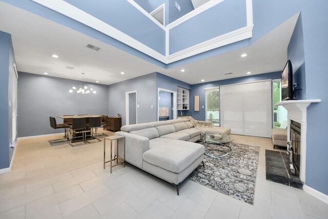 7655 S Braeswood Blvd Unit 10, Houston, TX 77071 - living area with a glass covered fireplace, a chandelier, baseboards, recessed lighting, and built in features