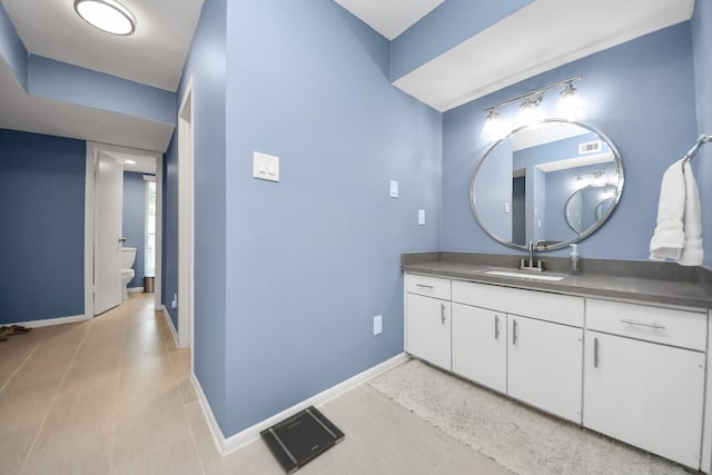 7655 S Braeswood Blvd Unit 10, Houston, TX 77071 - bathroom featuring vanity, toilet, baseboards, and tile patterned floors