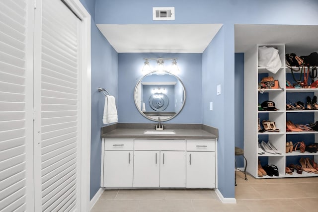 7655 S Braeswood Blvd Unit 10, Houston, TX 77071 - bathroom featuring tile patterned floors, vanity, and baseboards