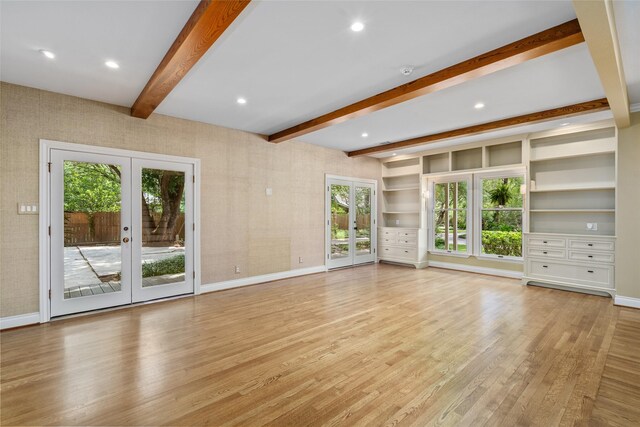 unfurnished living room with french doors, beam ceiling, baseboards, light wood-style flooring, and recessed lighting