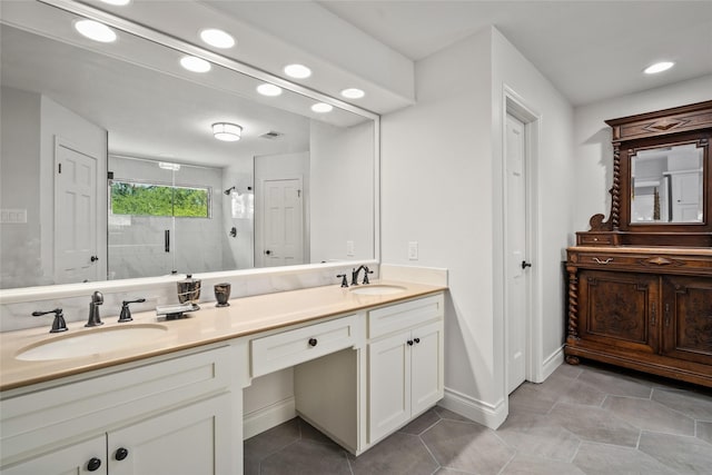 full bathroom with a shower stall, recessed lighting, double vanity, tile patterned floors, and baseboards