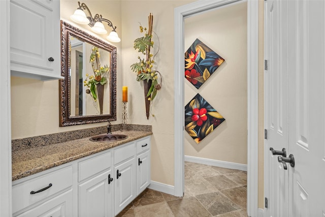 bathroom featuring baseboards and vanity