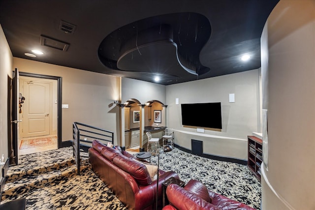 6417 Rodrigo St, Houston, TX 77007 - carpeted living room featuring arched walkways, decorative columns, and recessed lighting
