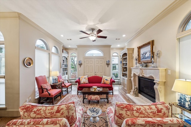 6417 Rodrigo St, Houston, TX 77007 - living room featuring wood finished floors, a glass covered fireplace, a ceiling fan, ornamental molding, and recessed lighting