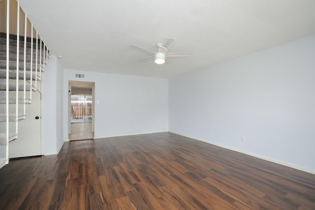 unfurnished living room featuring stairs, ceiling fan, dark wood finished floors, and visible vents