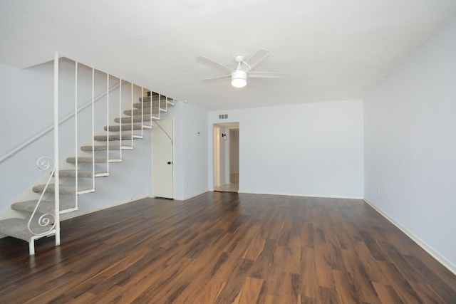 unfurnished living room with wood finished floors, stairway, baseboards, visible vents, and ceiling fan