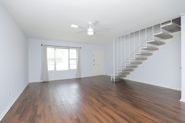 unfurnished living room with ceiling fan, stairs, baseboards, and wood finished floors