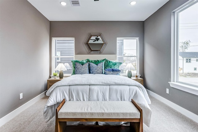 bedroom with recessed lighting, carpet, visible vents, and multiple windows