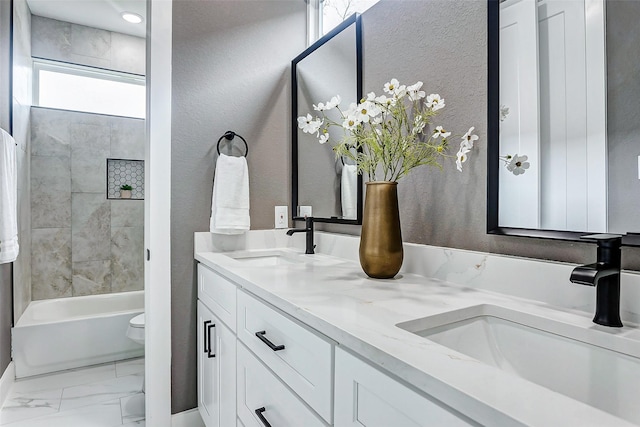 full bathroom with a sink, double vanity, toilet, and marble finish floor