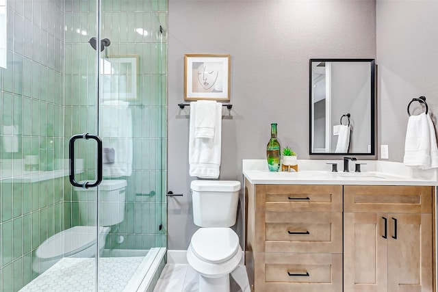 bathroom featuring toilet, vanity, and a shower stall