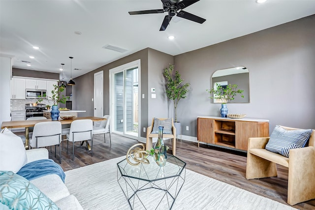 living room featuring recessed lighting, baseboards, visible vents, ceiling fan, and wood finished floors