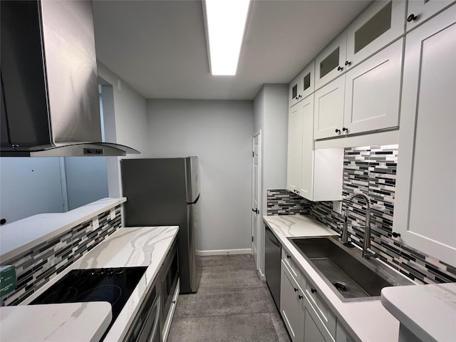 kitchen featuring ventilation hood, stainless steel appliances, decorative backsplash, and baseboards