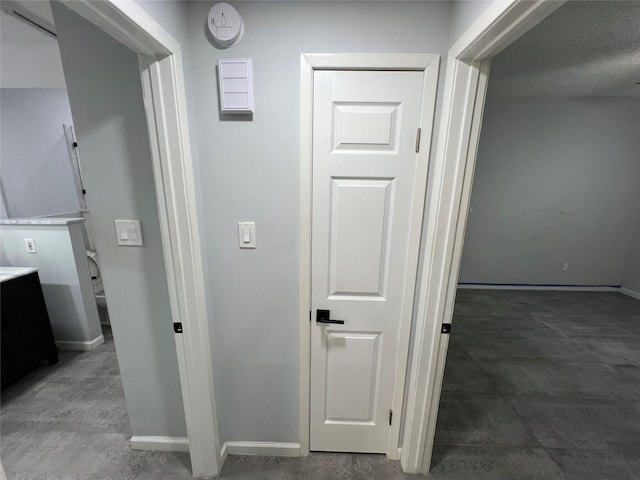 hallway featuring baseboards