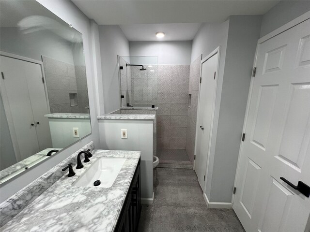bathroom with a walk in shower, vanity, toilet, and baseboards