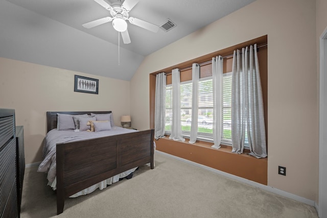 carpeted bedroom with vaulted ceiling, ceiling fan, baseboards, and visible vents