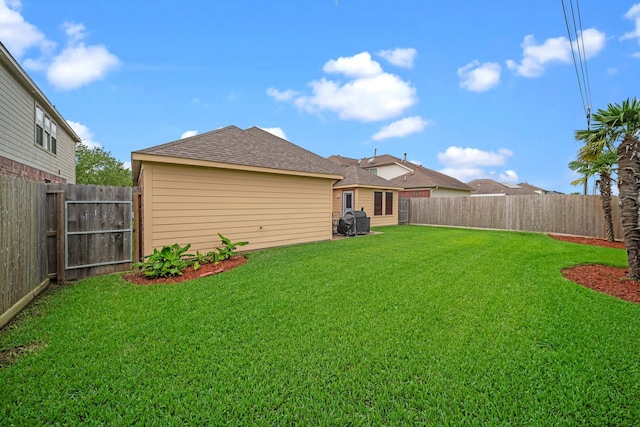 view of yard with a fenced backyard