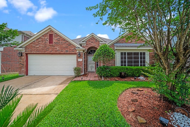 single story home with a garage, a front lawn, brick siding, and driveway