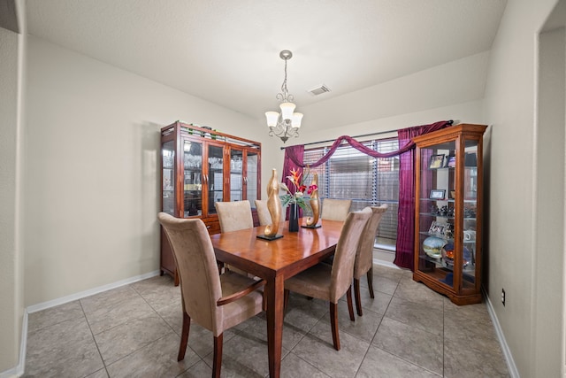 dining room featuring an inviting chandelier, light tile patterned flooring, baseboards, and visible vents