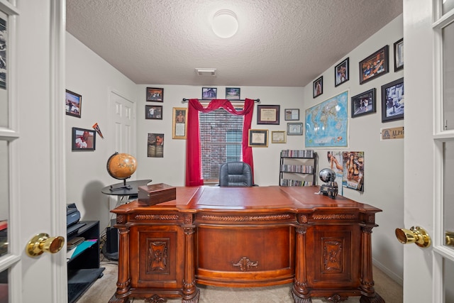 home office featuring visible vents and a textured ceiling