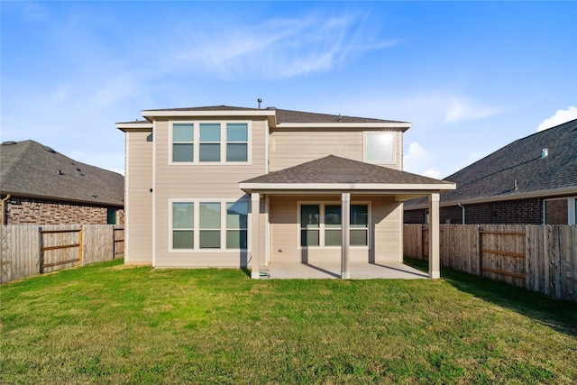 7611 Coral Key Dr, Cypress, TX 77433 - rear view of house with a yard, a shingled roof, a patio, and a fenced backyard