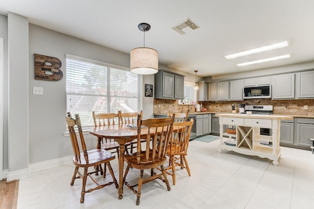 dining space with baseboards and visible vents