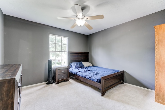 bedroom with baseboards, a ceiling fan, and carpet floors