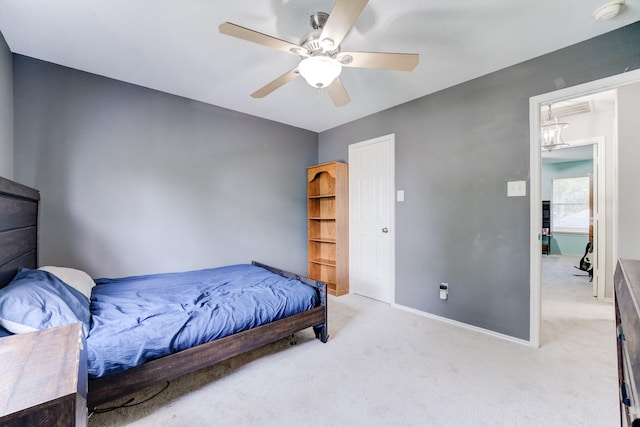 bedroom with light carpet, baseboards, and ceiling fan