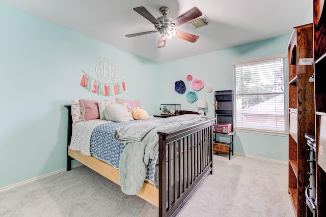 carpeted bedroom featuring visible vents, baseboards, and a ceiling fan