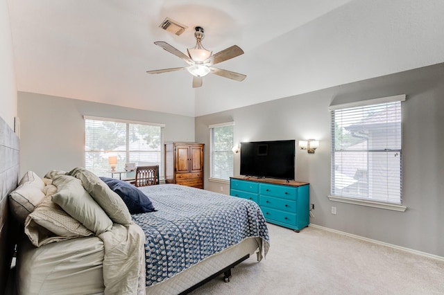 bedroom featuring a ceiling fan, visible vents, baseboards, light colored carpet, and vaulted ceiling