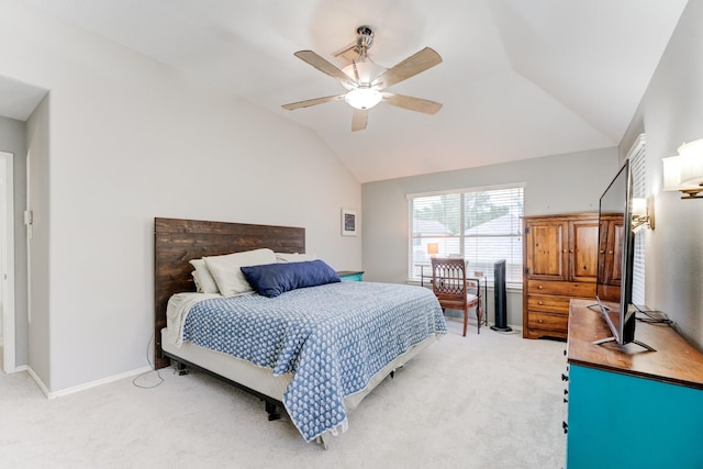 bedroom featuring light colored carpet, a ceiling fan, baseboards, and lofted ceiling