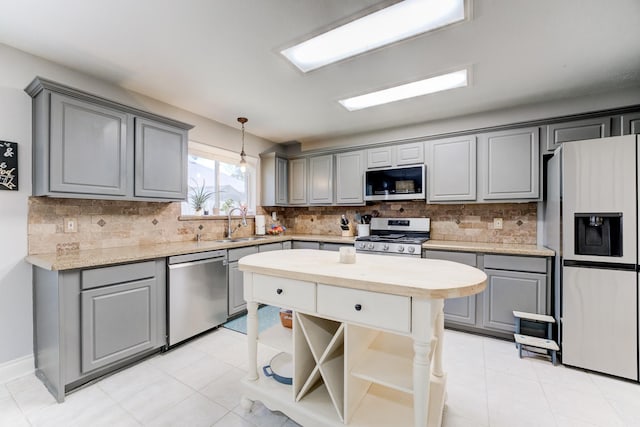 kitchen with pendant lighting, open shelves, tasteful backsplash, appliances with stainless steel finishes, and gray cabinets