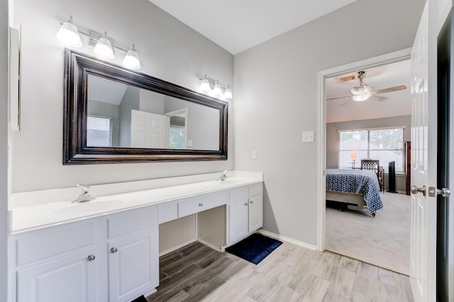 full bathroom featuring a sink, double vanity, a ceiling fan, and wood finished floors