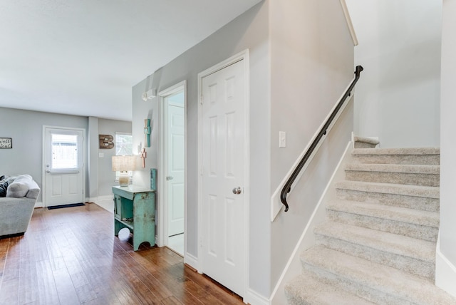 staircase featuring baseboards and hardwood / wood-style floors