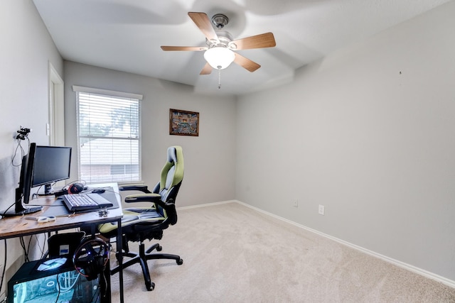 office with light colored carpet, baseboards, and a ceiling fan