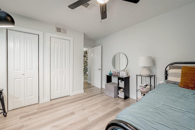 2406 Hillshire Dr, Deer Park, TX 77536 - bedroom featuring multiple closets, light wood-type flooring, baseboards, and ceiling fan