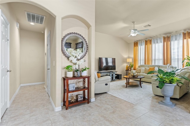 living area with ceiling fan, baseboards, light tile patterned floors, and visible vents