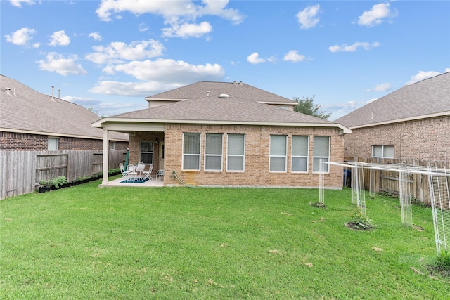 back of house featuring a patio area, brick siding, and a fenced backyard