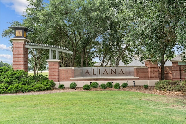 community sign featuring a lawn