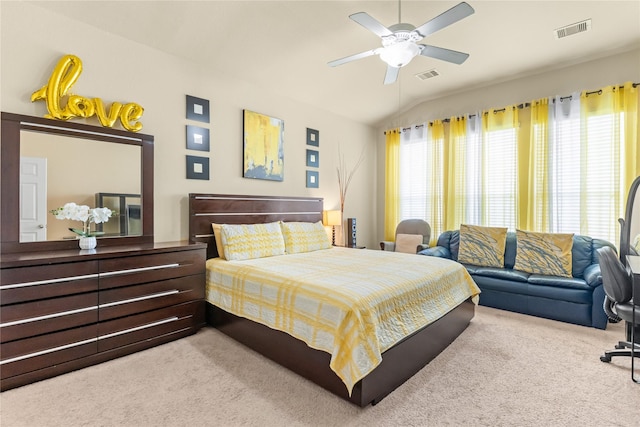 bedroom with lofted ceiling, carpet flooring, and visible vents