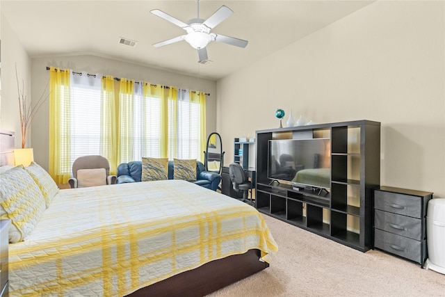 carpeted bedroom featuring visible vents, lofted ceiling, and ceiling fan