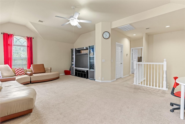living area with lofted ceiling, carpet flooring, visible vents, and a ceiling fan