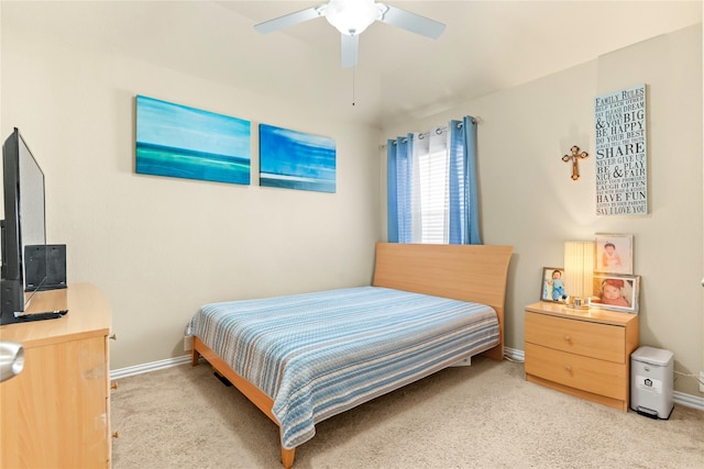 bedroom with light carpet, baseboards, and a ceiling fan